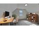 Bright office space featuring neutral walls, a large window, a modern desk setup, and stylish shelving for organized storage at 5012 Forest Mountain Ct, Charlotte, NC 28227