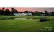 Aerial view of a beautiful golf course and white clubhouse nestled among trees at 6301 Royal Aberdeen Ct, Charlotte, NC 28277