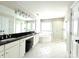 Bright bathroom featuring dual sinks, a soaking tub, a glass shower enclosure, and white tile at 6301 Royal Aberdeen Ct, Charlotte, NC 28277