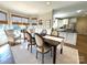 Bright dining area with windows, a view into the open kitchen, and access to the outdoors at 6301 Royal Aberdeen Ct, Charlotte, NC 28277