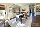 Inviting dining area with natural light and views of a modern, well-equipped kitchen at 6301 Royal Aberdeen Ct, Charlotte, NC 28277
