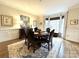 Elegant dining room with wainscoting, a round table, and a bay window with a serene view at 6301 Royal Aberdeen Ct, Charlotte, NC 28277