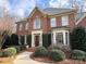 Charming brick home featuring manicured shrubs, a brick walkway, and a classic architectural design at 6301 Royal Aberdeen Ct, Charlotte, NC 28277