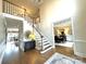 Grand foyer with a sweeping staircase, hardwood floors, and views into the formal dining room at 6301 Royal Aberdeen Ct, Charlotte, NC 28277