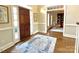 Welcoming foyer featuring hardwood floors, decorative rug, and an open view to a cozy living space at 6301 Royal Aberdeen Ct, Charlotte, NC 28277