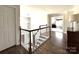 Upstairs hallway boasting hardwood floors, a light fixture, and views into other rooms at 6301 Royal Aberdeen Ct, Charlotte, NC 28277