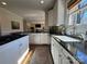 Well-lit kitchen featuring granite countertops, white cabinetry, and stainless steel appliances at 6301 Royal Aberdeen Ct, Charlotte, NC 28277