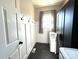 Functional laundry room complete with storage, hooks, and tile flooring at 6301 Royal Aberdeen Ct, Charlotte, NC 28277