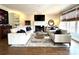 Inviting living room features a fireplace, large windows, hardwood floors, and comfortable seating at 6301 Royal Aberdeen Ct, Charlotte, NC 28277