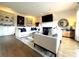 Bright living room featuring built-in bookshelves, a fireplace, hardwood floors, and neutral color palette at 6301 Royal Aberdeen Ct, Charlotte, NC 28277