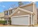 Home's two car garage featuring clean white doors and beige siding to match the exterior at 733 Rocky Grove Gln, York, SC 29745