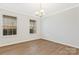 Bright living room with two sunny windows, neutral walls, white trim, and laminate flooring at 733 Rocky Grove Gln, York, SC 29745