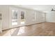 Spacious living room featuring vinyl floors, large windows and a glass paneled door at 733 Rocky Grove Gln, York, SC 29745