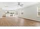 Open concept living room with vinyl floors, bright lighting and ceiling fan at 733 Rocky Grove Gln, York, SC 29745
