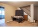 Finished basement with air hockey table and staircase to upper level at 7708 Ritter Dr, Charlotte, NC 28270