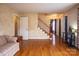 Inviting living room with hardwood floors, a staircase, neutral walls, and comfortable seating, perfect for relaxation at 7708 Ritter Dr, Charlotte, NC 28270