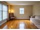 Sun-drenched living room with hardwood floors, a vintage chair, and a comfortable sofa, creating a cozy atmosphere at 7708 Ritter Dr, Charlotte, NC 28270