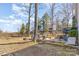 Expansive backyard featuring a tire swing, treehouse, outdoor seating, and ample space for recreation and relaxation at 7732 Wingmont Dr, Charlotte, NC 28269