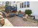 Inviting backyard patio with brick pavers, outdoor seating, and a deck overlooking the serene outdoor space at 7732 Wingmont Dr, Charlotte, NC 28269