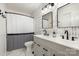 Modern bathroom with double vanity, sleek black fixtures, and stylish wallpaper at 7732 Wingmont Dr, Charlotte, NC 28269