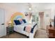 Bright bedroom featuring a colorful rainbow mural, a bed with throw pillows, and decor at 7732 Wingmont Dr, Charlotte, NC 28269