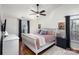 Bedroom featuring hardwood floors, a ceiling fan, neutral decor, and two bedside tables at 7732 Wingmont Dr, Charlotte, NC 28269