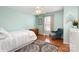 Charming bedroom with hardwood floors and a cozy chair, complemented by a serene window view at 7732 Wingmont Dr, Charlotte, NC 28269