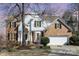 Charming two-story home with brick and white siding, complemented by a well-manicured front yard and a two-car garage at 7732 Wingmont Dr, Charlotte, NC 28269