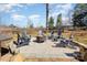 Outdoor fire pit with Adirondack chairs in a pea gravel bed with brick border, perfect for gatherings and relaxing outdoors at 7732 Wingmont Dr, Charlotte, NC 28269