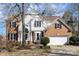 Charming two-story home with brick accents, a well-maintained lawn, and a welcoming front entrance at 7732 Wingmont Dr, Charlotte, NC 28269