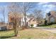 Traditional home with brick and white siding, a well-manicured lawn, and a spacious driveway at 7732 Wingmont Dr, Charlotte, NC 28269