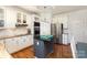 Bright kitchen featuring an island, stainless steel appliances, granite countertops, and white cabinets at 7732 Wingmont Dr, Charlotte, NC 28269