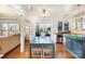 Kitchen with hardwood floors, stainless steel appliances, granite countertops, and an adjacent breakfast nook at 7732 Wingmont Dr, Charlotte, NC 28269