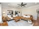 Living room featuring hardwood floors, area rug, two sofas, and an open floorplan leading to the kitchen at 7732 Wingmont Dr, Charlotte, NC 28269