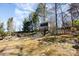 Charming backyard treehouse connected by a bridge, offering a playful outdoor escape and adventure at 7732 Wingmont Dr, Charlotte, NC 28269