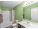 Bathroom featuring shower/tub, a framed mirror, and a vanity with marble countertop and green painted walls at 8028 Tricia Pointe Pl, Indian Land, SC 29707