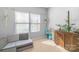 Bright bedroom with two windows, a seating area, neutral walls, and hardwood furniture for storage at 8028 Tricia Pointe Pl, Indian Land, SC 29707