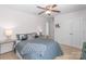 This cozy bedroom features neutral walls and flooring, a ceiling fan, and modern decor at 8028 Tricia Pointe Pl, Indian Land, SC 29707