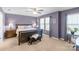 Bedroom with natural light, a ceiling fan, and a wooden bed frame, bedside tables with lamps, and wood flooring at 8028 Tricia Pointe Pl, Indian Land, SC 29707