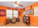 This Virginia Tech-themed bedroom features bright orange walls, a ceiling fan, and lots of Hokies memorabilia at 8028 Tricia Pointe Pl, Indian Land, SC 29707