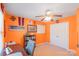 This bright bedroom features orange walls and is decorated with Virginia Tech sports memorabilia at 8028 Tricia Pointe Pl, Indian Land, SC 29707