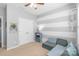 Serene bedroom with striped accent wall, plush carpet, and ample natural light, perfect for relaxation at 8028 Tricia Pointe Pl, Indian Land, SC 29707