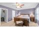 Bedroom with natural light, a ceiling fan, and a wooden bed frame, bedside tables with lamps, and wood flooring at 8028 Tricia Pointe Pl, Indian Land, SC 29707