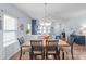 Open-concept dining area with wood flooring, neutral walls, and direct view into living room at 8028 Tricia Pointe Pl, Indian Land, SC 29707