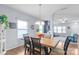 Bright dining room with a wooden table, seating for six, and views into the living area at 8028 Tricia Pointe Pl, Indian Land, SC 29707