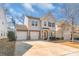 Charming two-story home with a three-car garage, well-maintained landscaping, and inviting front porch at 8028 Tricia Pointe Pl, Indian Land, SC 29707
