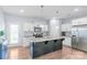 Bright kitchen features stainless steel appliances, a granite-topped island, and modern finishes at 8028 Tricia Pointe Pl, Indian Land, SC 29707