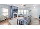 Bright living room with a cozy fireplace, large windows, and comfortable seating, perfect for relaxing at 8028 Tricia Pointe Pl, Indian Land, SC 29707