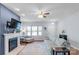 Sun-filled living room with a fireplace, neutral decor, and ample seating, creating a warm and inviting atmosphere at 8028 Tricia Pointe Pl, Indian Land, SC 29707