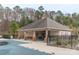 Community pool and pool house surrounded by picnic tables and ample seating at 8028 Tricia Pointe Pl, Indian Land, SC 29707